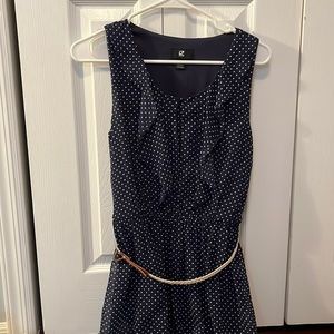 mid length navy blue dress with tan belt and white polka dots